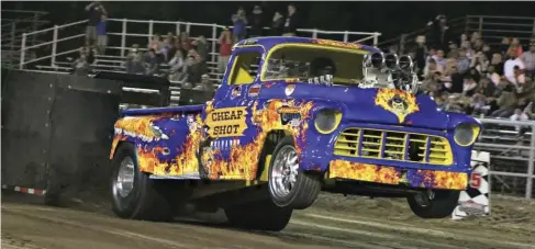  ??  ??  No, it’s not a diesel, but who doesn’t love seeing big-block Chevy, running straight alcohol, with a massive blower sticking out of the hood, carrying both front wheels 5 feet in the air all the way down a dirt track? The old Chevy, Cheap Shot...