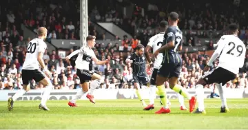 ??  ?? Manchester City’s Bernardo Silva scores their first goal during the English Premier League football match between Fulham and Manchester City at Craven Cottage in London. — Reuters photo