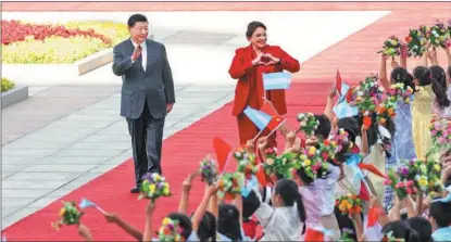  ?? FENG YONGBIN / CHINA DAILY ?? President Xi Jinping and visiting Honduran President Iris Xiomara Castro Sarmiento are greeted by children during a welcoming ceremony, on June 12, in Beijing.