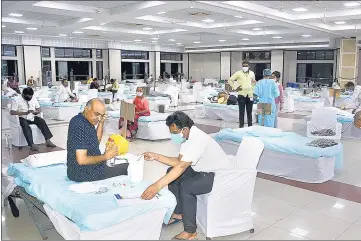  ??  ?? Covid-19 patients being treated in an isolation centre arranged by Saurashtra Patel Samaj Community at Ambatalavd­i Katargam, in Surat on Saturday.
