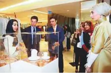  ?? WAM ?? Sulaiman Al Mazroui, Reem Bin Karam and Leo Fenwick look at a display of Shaikha Hind’s porcelain collection.