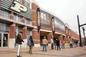  ?? Nikos Frazier / Associated Press ?? Voters line up Oct. 14 outside Purdue University's Mackey Arena for early voting ahead of the 2020 general election in West Lafayette, Ind.