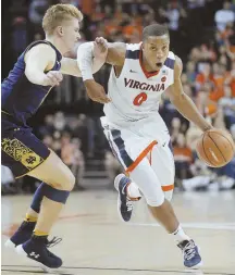  ?? Ap photo ?? DRIVEN: Virginia guard Devon Hall drives past Notre Dame guard Rex Pflueger yesterday.