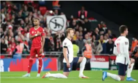  ?? Photograph: Paul Marriott/Shuttersto­ck ?? A Hungary fan makes a point with a banner as England players take the knee at Wembley.