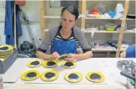  ??  ?? Potter Caroline Tattersall hard at work in her Poynton Pottery, making ceramic sunflowers