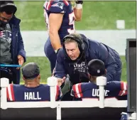  ?? Elise Amendola / Associated Press ?? Patriots coach Bill Belichick instructs defenders Terez Hall, left, and Josh Uche on the sideline during Monday’s game against Buffalo.