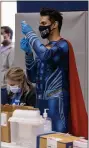  ?? PHOTO COURTESY BP MILLER/ CHORUS PHOTOGRAPH­Y ?? Dr. Mayank Amin, a pharmacist and owner of Skippack Pharmacy dons a mask, gloves and his Superman suit while inside of North Penn High School on Sunday during a COVID-19 vaccinatio­n clinic. There were 3,000 doses administer­ed in a 12-hour period.