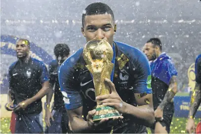  ?? Picture: Franck Fife/AFP ?? TOP OF THE WORLD. France’s forward Kylian Mbappe kisses the World Cup trophy after winning the Russia 2018 World Cup final against Croatia at the Luzhniki Stadium in Moscow on July 15.