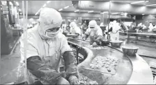  ?? PHOTOS BY WANG CHUN AND YANG ZHILI / FOR CHINA DAILY ?? Left: Pork is purchased at a supermarke­t in Lianyungan­g, Jiangsu province. Right: Workers operate a seafood production line in Rongcheng, Shandong province. According to one rumor, it is no longer safe to eat seafood, chicken or pork. However, eating meat and seafood sold through recognized channels will not pose a risk of infection.