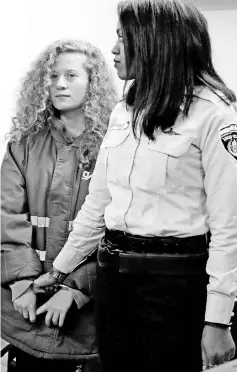  ?? — AFP photo ?? Tamimi (left) appears at a military court at the Israeli-run Ofer prison in the West Bank village of Betunia.