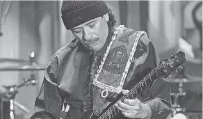  ?? FRANK MICELOTTA/ GETTY IMAGES ?? In this 2005 photo, Carlos Santana dives into a solo. His story is the subject of a new documentar­y “Carlos.”