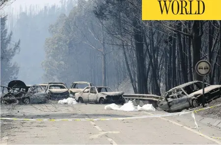  ?? ARMANDO FRANCA / THE ASSOCIATED PRESS ?? Burned-out cars line the road between Castanheir­a de Pera and Figueiro dos Vinhos, central Portugal, on Sunday after flames from a large-scale forest fire swept over the area, killing scores of people.