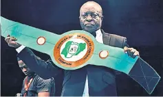  ?? — AFP photo ?? Boxing promoter Raufu Ladipo displays a lightweigh­t belt to be contested by boxers during a GOtv title fight at the sport hall National Stadium in Lagos in this April 15 file photo.