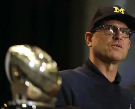  ?? PHOTOS BY G-JUN YAM — THE ASSOCIATED PRESS ?? Michigan NCAA college football head coach Jim Harbaugh speaks at Big Ten Media Day in Chicago, Monday.