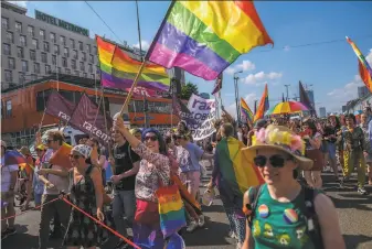  ?? Omar Marques / Getty Images ?? LGBT community supporters join the Equality Parade in Warsaw. Polish gay rights supporters have faced a backlash from ruling conservati­ves, local communitie­s and the Catholic Church.