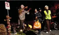  ?? CARLOS OSORIO/TORONTO STAR FILE PHOTO ?? These trick-or-treaters would be violating a New Brunswick town’s bylaw by collecting chocolate and candy past 7 p.m. on Halloween.