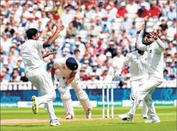  ??  ?? India’s Ravichandr­an Ashwin (L) celebrates a wicket of England's Alastair Cook on the first day of the first Test at Edgbaston on Wednesday.