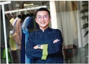  ?? — ART CHEN/The Star ?? Khoon Hooi says there is a spike of non-traditiona­lists purchasing their first cheongsam these days.