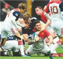  ?? AFP ?? Scotland players tackle France’s prop Cyril Baille (second from right) during the Six Nations match at the Stade de France in Saint-Denis, on Sunday.