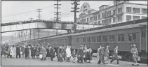  ?? (File Photo/AP) ?? Seattle crowds jam an overhead walk in March 1942 to witness mass evacuation of Japanese from Bainbridge Island, Wash. Somewhat bewildered, but not protesting, some 200 Japanese men, women and children were taken by ferry, bus and train to California internment camps. Evacuation was carried out by the Army.