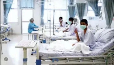  ?? THAILAND GOVERNMENT SPOKESMAN BUREAU VIA AP ?? Three of the 12 boys are seen recovering in their hospital beds after being rescued along with their coach from a flooded cave in Mae Sai, Chiang Rai province, northern Thailand.