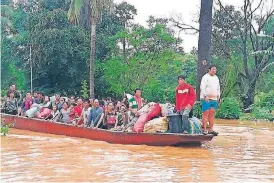  ?? [ATTAPEU TV VIA AP] ?? People on a boat are evacuated in the floodwater­s from a collapsed dam Tuesday in southeaste­rn Laos. Rescue efforts are ongoing in villages flooded after part of a newly built hydroelect­ric dam was breached in southeaste­rn Laos.