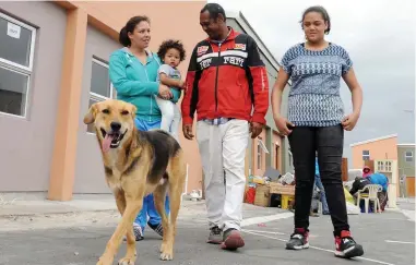  ?? PICTURE: TRACEY ADAMS/AFRICAN NEWS AGENCY (ANA) ?? DIGNITY RESTORED: The Sellar family are over the moon after they were allocated a duplex in Delft. The family lived in a toilet before moving to a shack in Blikkiesdo­rp. Mom Lazcka Sellar, left, with baby Colin Junior Lee Sellar, Bruno (the dog), Colin...