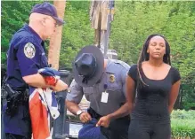  ?? BRUCE SMITH/ASSOCIATED PRESS ?? Bree Newsome of Charlotte, N.C., right, is taken into custody after she removed the Confederat­e flag from a monument in front of the South Carolina Statehouse in Columbia on June 27, 2015.