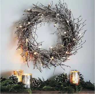  ?? WEST ELM/THE ASSOCIATED PRESS ?? Battery-powered LED lights and glitter turn a twig wreath into holiday art.