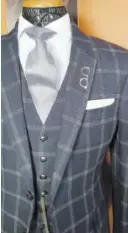  ??  ?? A linen windowpane-plaid three-piece suit in navy is the essence of sartorial glamour.