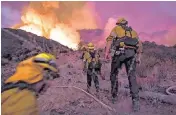  ?? WALLY SKALIJ Los Angeles Times/TNS ?? Firefighte­rs make their way up a hill as the El Dorado fire approaches on Sept. 1, 2020, in Yucaipa, California. The American Climate Corps has openings for job seekers who want to help protect forests from wildfire in California.