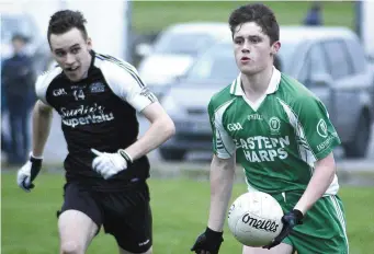  ??  ?? Brian Molloy in possession for Eastern Harps during their Minor game in Tubbercurr­y. Pic: T Callanan.