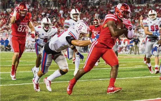  ?? Joe Buvid ?? UH running back Duke Catalon, right, gave SMU’s defense fits Saturday night, rushing for a career-high 177 yards to go with two touchdowns at TDECU Stadium.