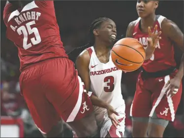  ?? NWA Democrat-Gazette/J.T. Wampler ?? BREAKING DOWN: Arkansas’ Malica Monk (3) gets her shot broken up by Alabama’s Ashley Knight (25) and Shaquera Wade (23) Sunday. Arkansas lost 83-76.