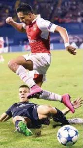  ??  ?? Arsenal forward Alexis Sanchez (ton) vies with Dinamo Zagreb defender Filip Benkovic during yesterday’s Champions League Group F match in Zagreb. – AFPPIX