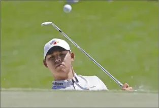  ?? The Associated Press ?? Si Woo Kim of South Korea chips onto the third green during the final round of The Players Championsh­ip on Sunday in Ponte Vedra Beach, Fla. Kim won the tournament with a total score of 10-under 278.