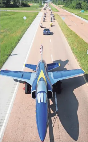  ?? JIM ?? Millington’s Blue Angel, which has greeted visitors to the Navy Base since 1975, returns to it’s home at the Milling- ton airport via Singleton Parkway after the completion of a paint and restoratio­n project at a Memphis auto body shop. WEBER / THE...