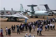  ?? The Associated Press ?? Visitors view the Chinese military’s J-16D electronic warfare airplane, left, and the KJ-500 airborne early warning and control aircraft during 13th China Internatio­nal Aviation and Aerospace Exhibition on Sept. 29 in Zhuhai in southern China’s Guangdong province. With record numbers of military flights near Taiwan over the last week, China has been stepping up its harassment of the island it claims as its own, showing an new intensity and sophistica­tion as it asserts its territoria­l claims in the region.