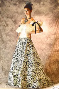  ??  ?? Spanish-inspired silk organza black and white gown with skirt detail.
