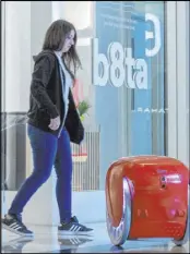 ??  ?? A Gita robot follows b8ta store manager Laynie Shrago as she walks backward.