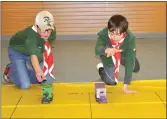  ?? Photos by Matthew Liebenberg/Prairie Post ?? Scouts Layton Diemert (at left) and Logan Beach, both 11 years old, push their trucks off the start line at the Swift Current Group 2 Scouts Kub Kar Rally, March 19.