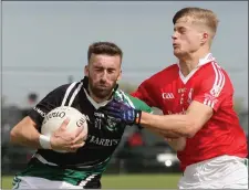  ??  ?? Daithí Moore of Kilmore is challenged by Ronan Devereux.