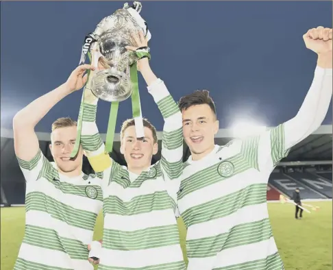  ?? Picture: SNS ?? Celtic players Mark Hill, Regan Hendry and Josh Kerr hold the City of Glasgow Cup aloft after beating Rangers at Hampden Park last night. The game was played behind closed doors because of crowd trouble at the fixture in recent years. Match report,...