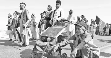  ?? — AFP photo ?? Afghan peace activists shouting slogans in demand to an end to the war as they start their march from Helmand to Kabul in Ghazni province.