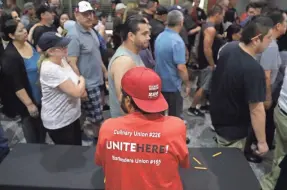 ??  ?? Culinary Union members leave after voting on whether to authorize a strike in Las Vegas on May 22. There appears to be a tentative labor agreement that would cover about a quarter of the 50,000 hotel and casino workers who are threatenin­g to strike....