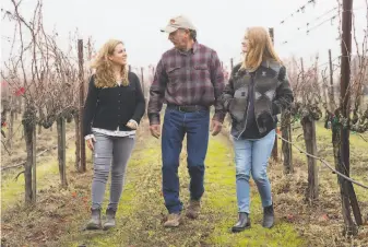  ?? Jessica Christian / The Chronicle 2019 ?? Above: Elise Nerlove Rutchick (left) with father Ken Nerlove and fellow Save the Family Farms member Hayley Hossfeld at Elkhorn Peak Cellars in Napa. Below: The vineyards of Elkhorn Peak on a foggy morning. Right: The grounds and gardens of Hoopes Vineyard.