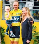  ??  ?? Tour de France winner Christophe­r Froome celebrates with wife Michelle Cound and their baby in Paris at the Champs-Elysees on Sunday. — AFP