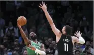  ?? CHARLES KRUPA — THE ASSOCIATED PRESS ?? Boston Celtics guard Jaylen Brown, left, shoots while pressured by Milwaukee Bucks center Brook Lopez (11) during the first half of Game 2of an Eastern Conference semifinal,tuesday.