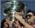  ?? MEL EVANS — ASSOCIATED PRESS ?? In a 2006 photo, John Campbell, right, holds up the Hambletoni­an trophy at Meadowland­s Racetrack in East Rutherford, N.J., after winning the race for the sixth time.