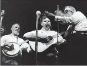  ?? Associated Press ?? DOC WATSON, center, performing with the Watson Family at the Newport Folk Festival in 1963.